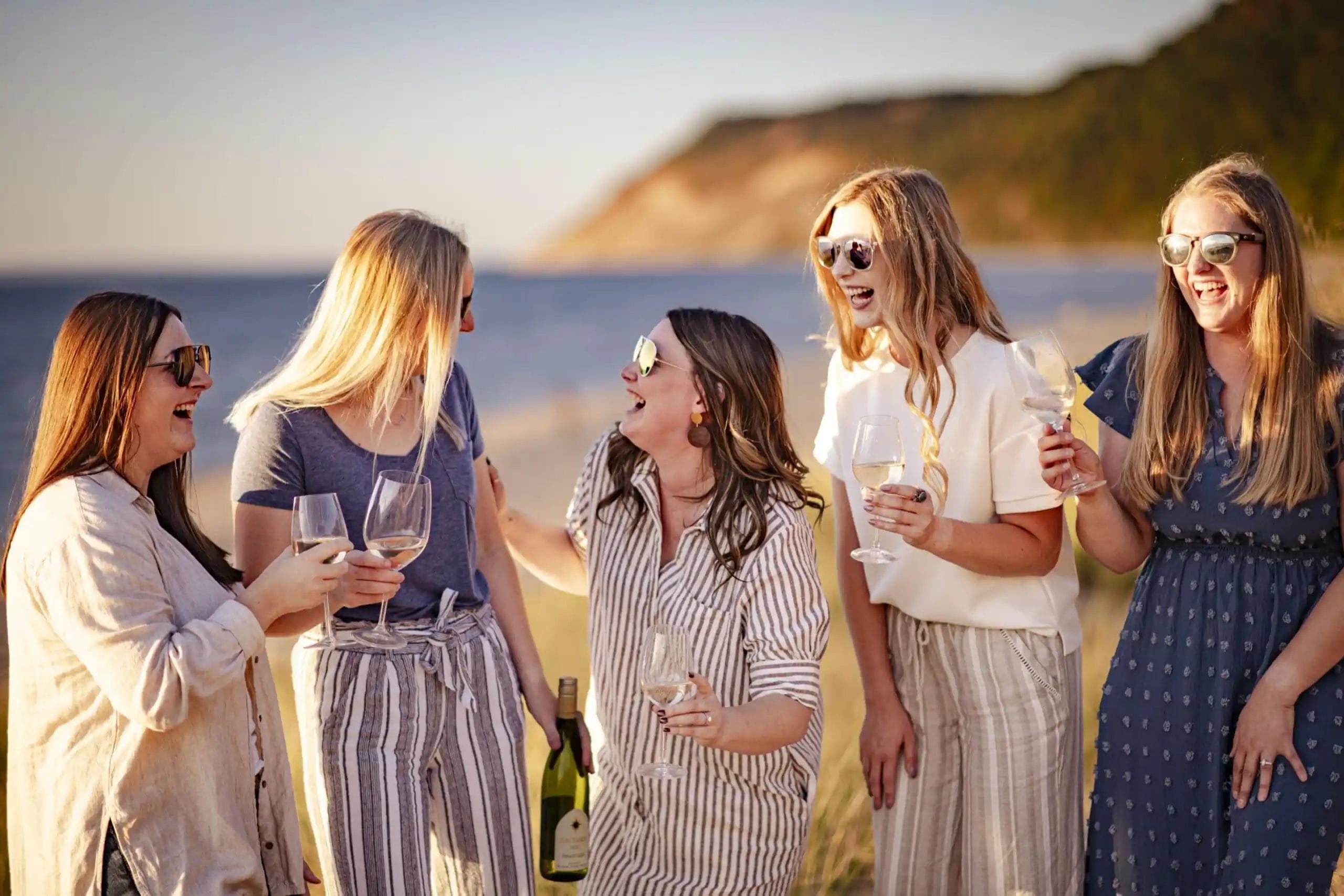 A man pouring wine into a glass at a restaurant table.