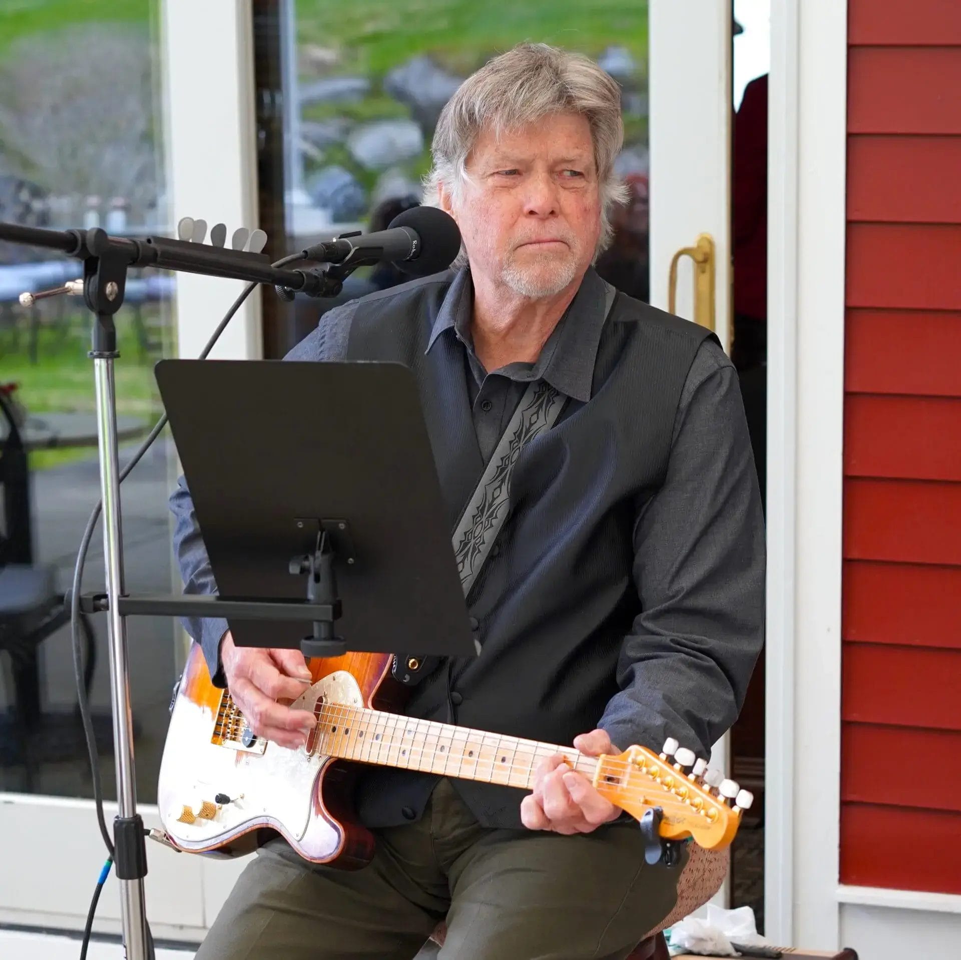 A diverse group of musicians playing instruments in a recording studio.