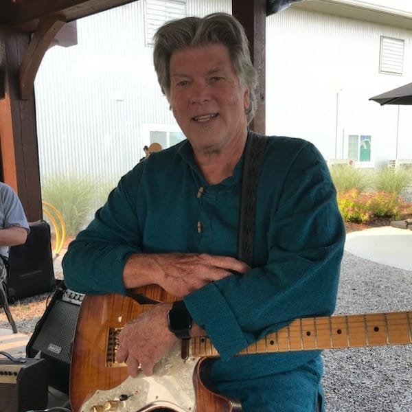 A diverse group of musicians playing instruments in a recording studio.