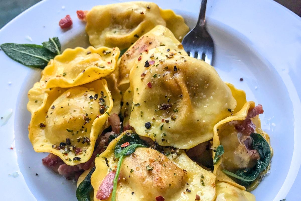 Bowl of stuffed handmade pasta with herbs